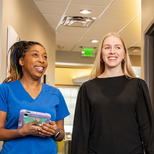 woman and team member smiling during visit